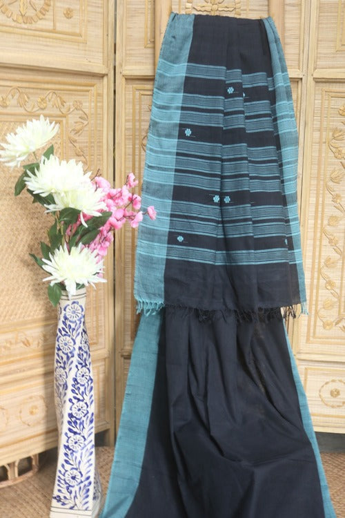 A beautiful Black with blue butis all over with a contrast blue plain border and Pallu