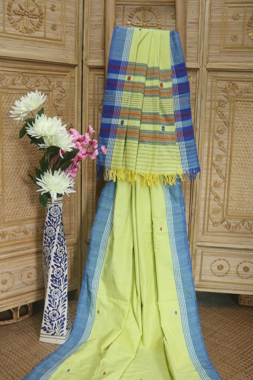 A light lemon yellow with red and blue butis all over with a contrast blue plain border and Pallu - Sarikart Online